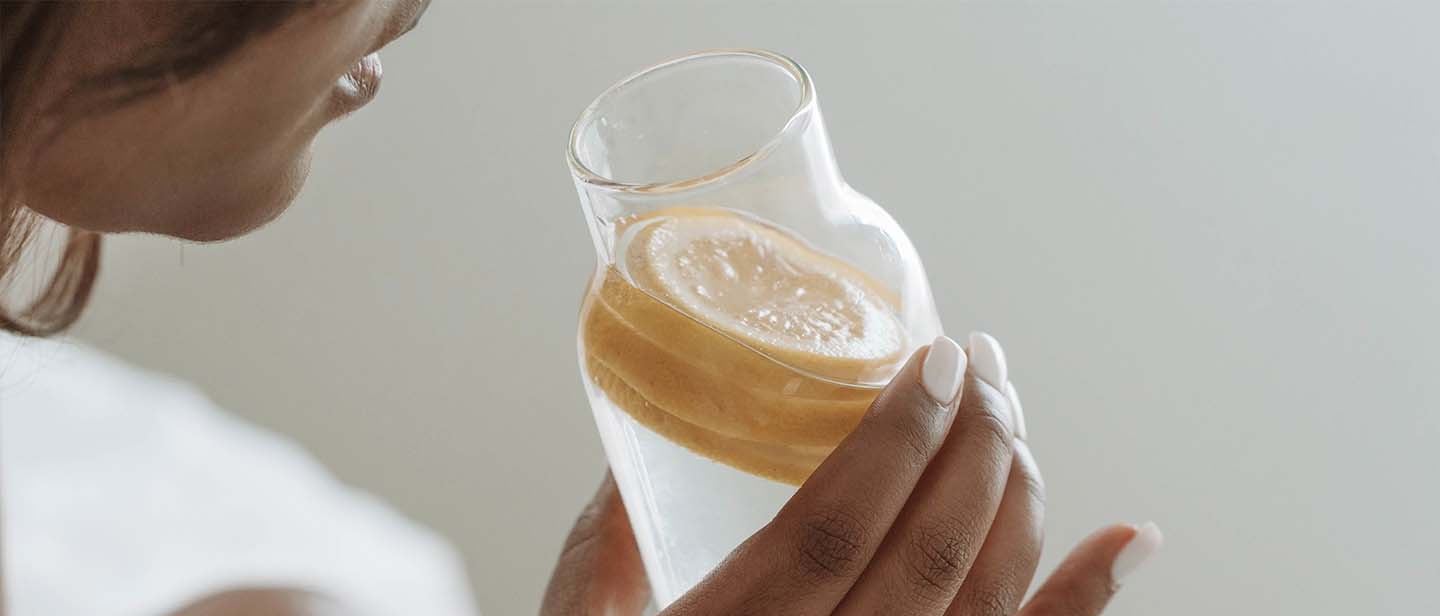 Women drinking water with lemon
