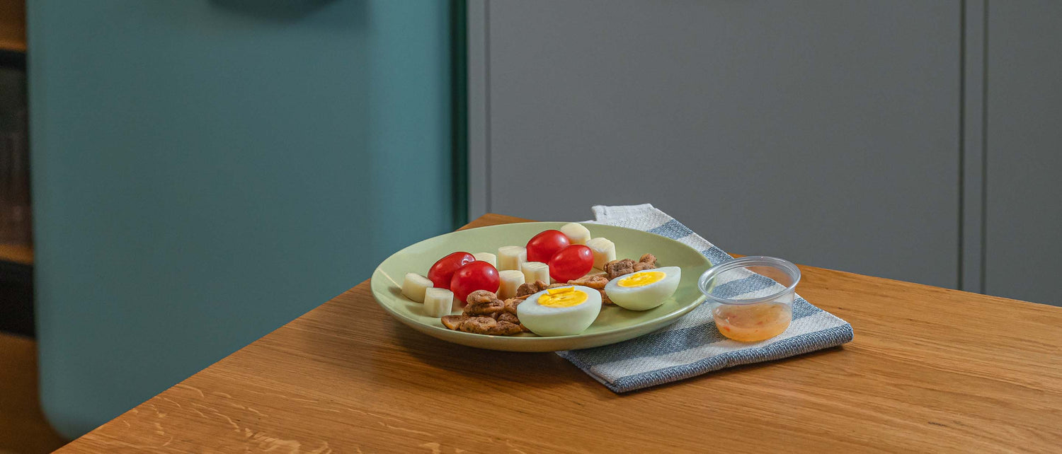 Mozzarella cheese, a hard-boiled egg, roasted chickpeas, and tomatoes