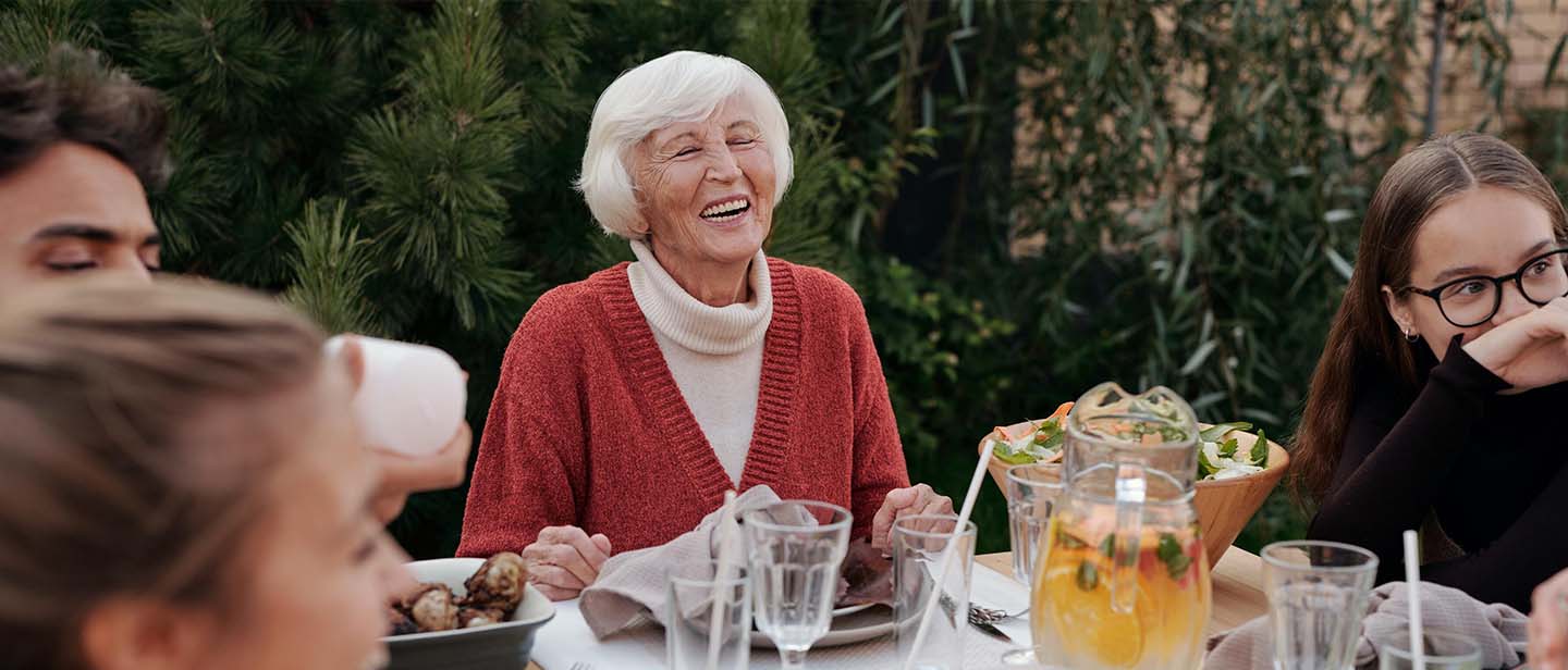 Youthful older lady at a dinner party