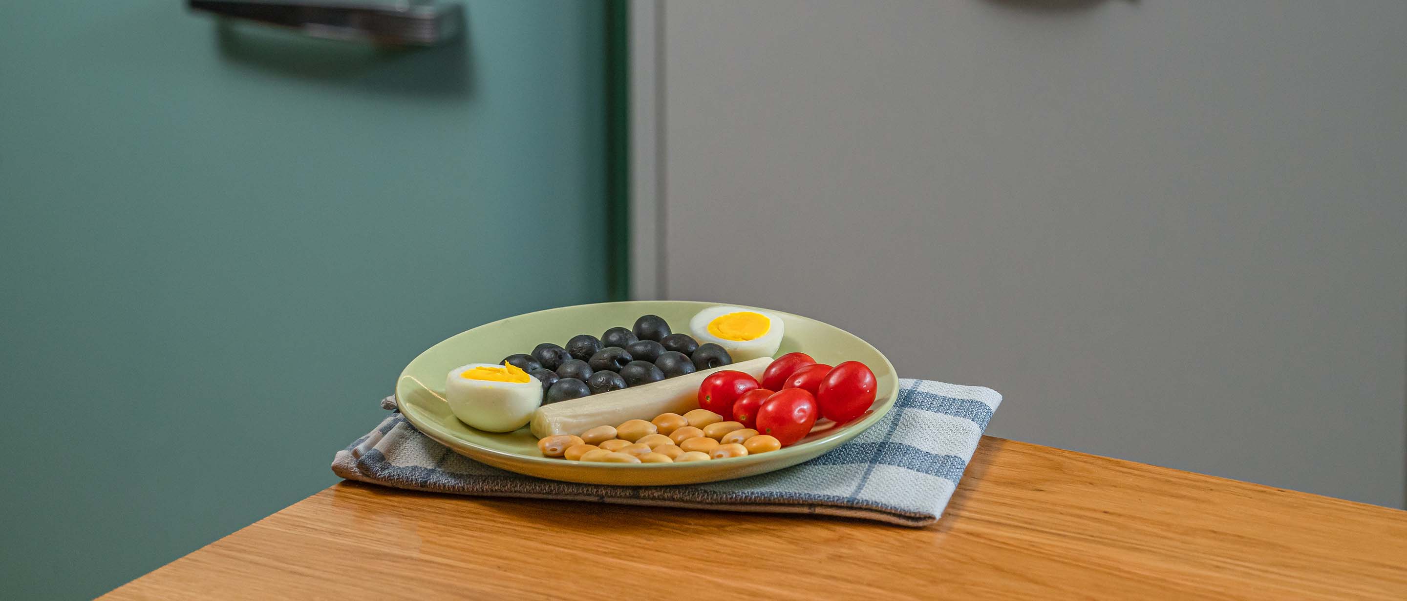 Mozzarella cheese, a hard-boiled egg, lupini beans, olives, and tomatoes 